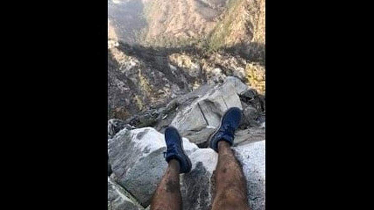 A hiker rescued from the Angeles National Forest with the help of a photo he sent a friend was found in a restricted burn area, California officials say.