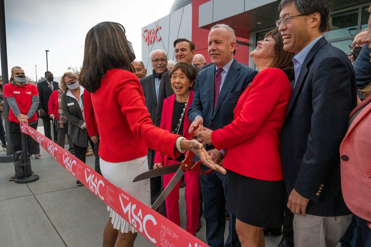 Shahnaz Van Deventer, left, director of marketing and development at SMUD Museum of Science and Curiosity, goes over the plan for the ceremonial ribbon-cutting for the museum’s opening on Nov. 12, 2021, with Rep. Doris Matsui, center, Mayor Darrell Steinberg, MOSAC executive director Michele Wong and state Sen. Richard Pan.