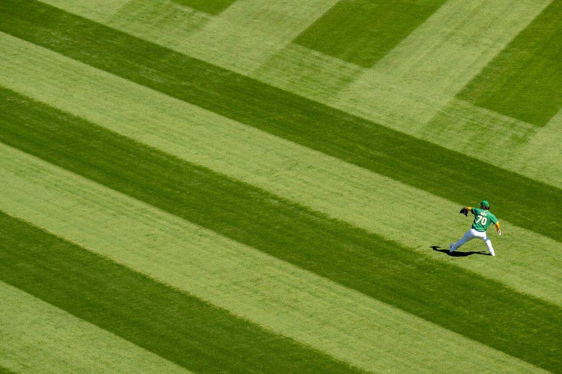 Oakland A’s starting pitcher J.T. Ginn warms up before the final home game at Oakland-Alameda County Coliseum on Thursday.