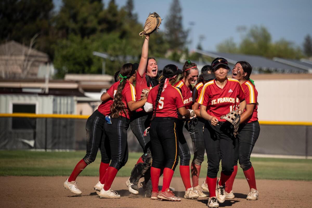 St. Francis catcher Grace Jenkins raises her glove as the team celebrates the last out of their game against Elk Grove during the Sac-Joaquin Section high school softball semifinal Tuesday, May 24, 2022, at St. Francis Catholic High School in Sacramento.