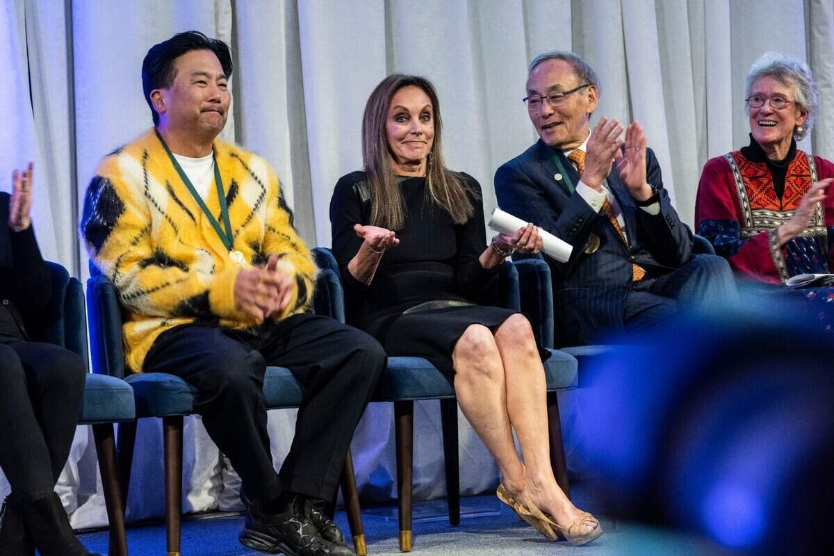 Ice skater Peggy Fleming, center, reacts as she’s inducted into the California Hall of Fame on Tuesday, Dec. 13, 2022, in Sacramento, as she sits between chef Roy Choi, left, and physicist Steven Chu, right.