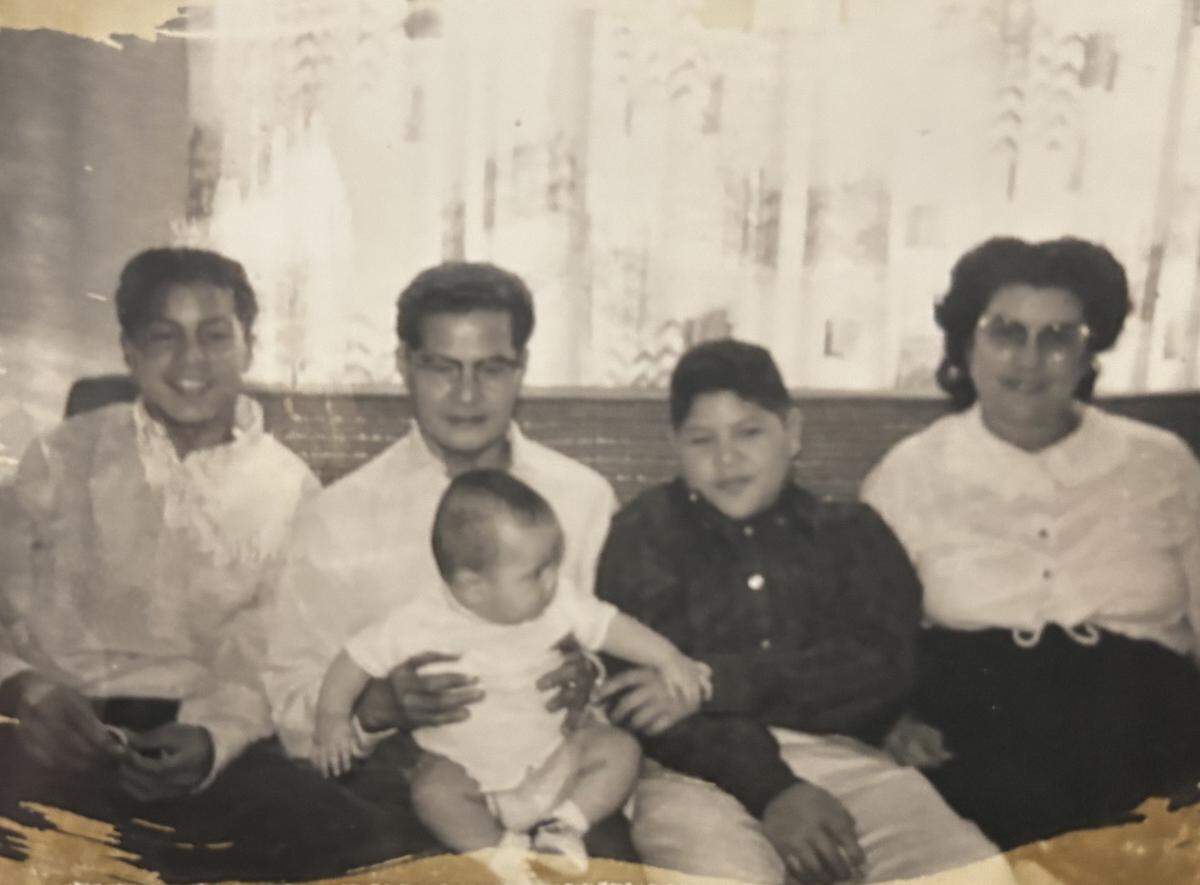 Manuel Gines, far left, sits with, from right, his father James Gines, an unidentified baby, his younger brother Frederick Gines and his mother Peggy Gines. Frederick Gines died of leukemia in 1963 at age 14.