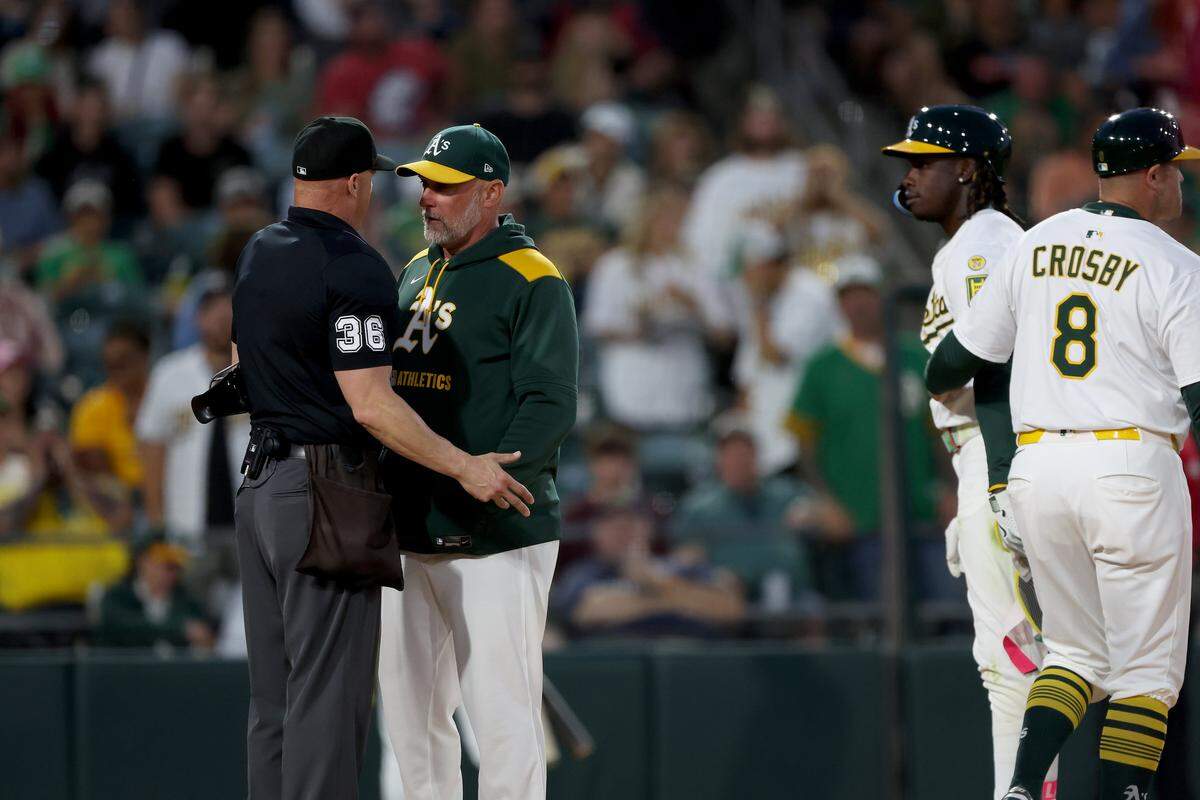 Jun 21, 2025; West Sacramento, California, USA; Athletics manager Mark Kotsay (7) discusses with home plate umpire Ryan Blankney (36) after ejecting Lawrence Butler (not pictured) against the Cleveland Guardians during the fifth inning at Sutter Health Park. Mandatory Credit: Dennis Lee-Imagn Images