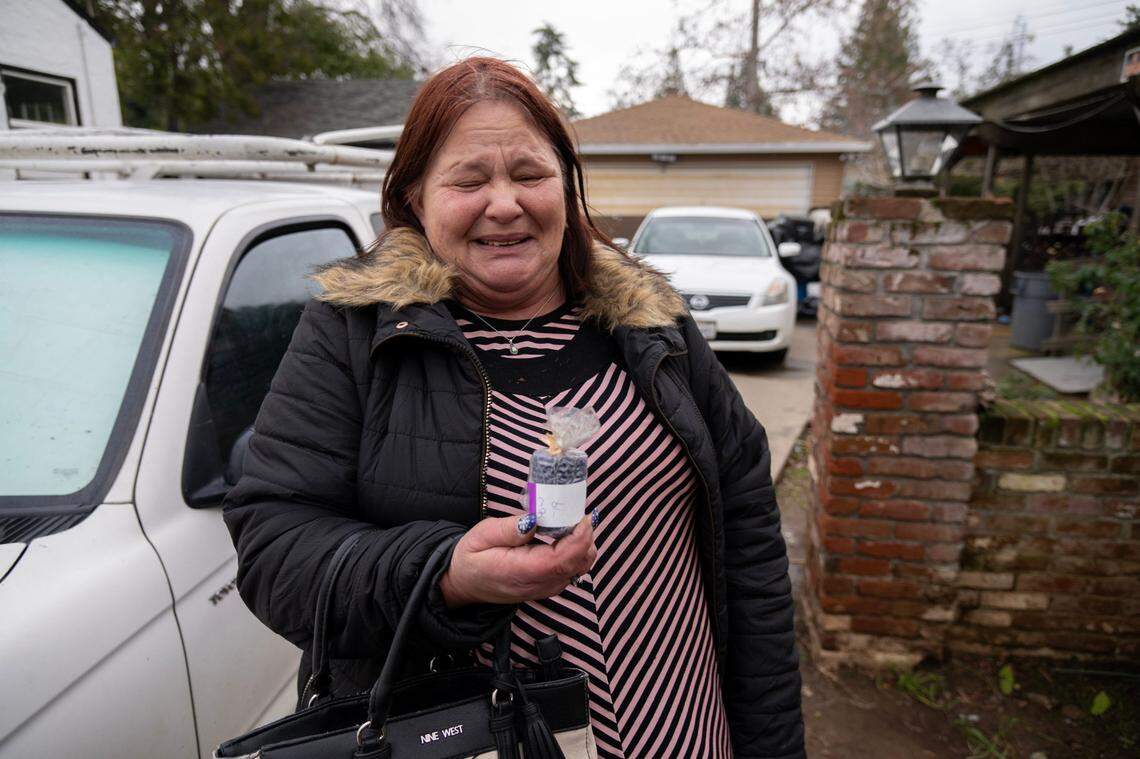 Michelle Christoff found two candles at a local thrift store to help light her home in the Wooklake neighborhood of Sacramento on Tuesday after three days without power.