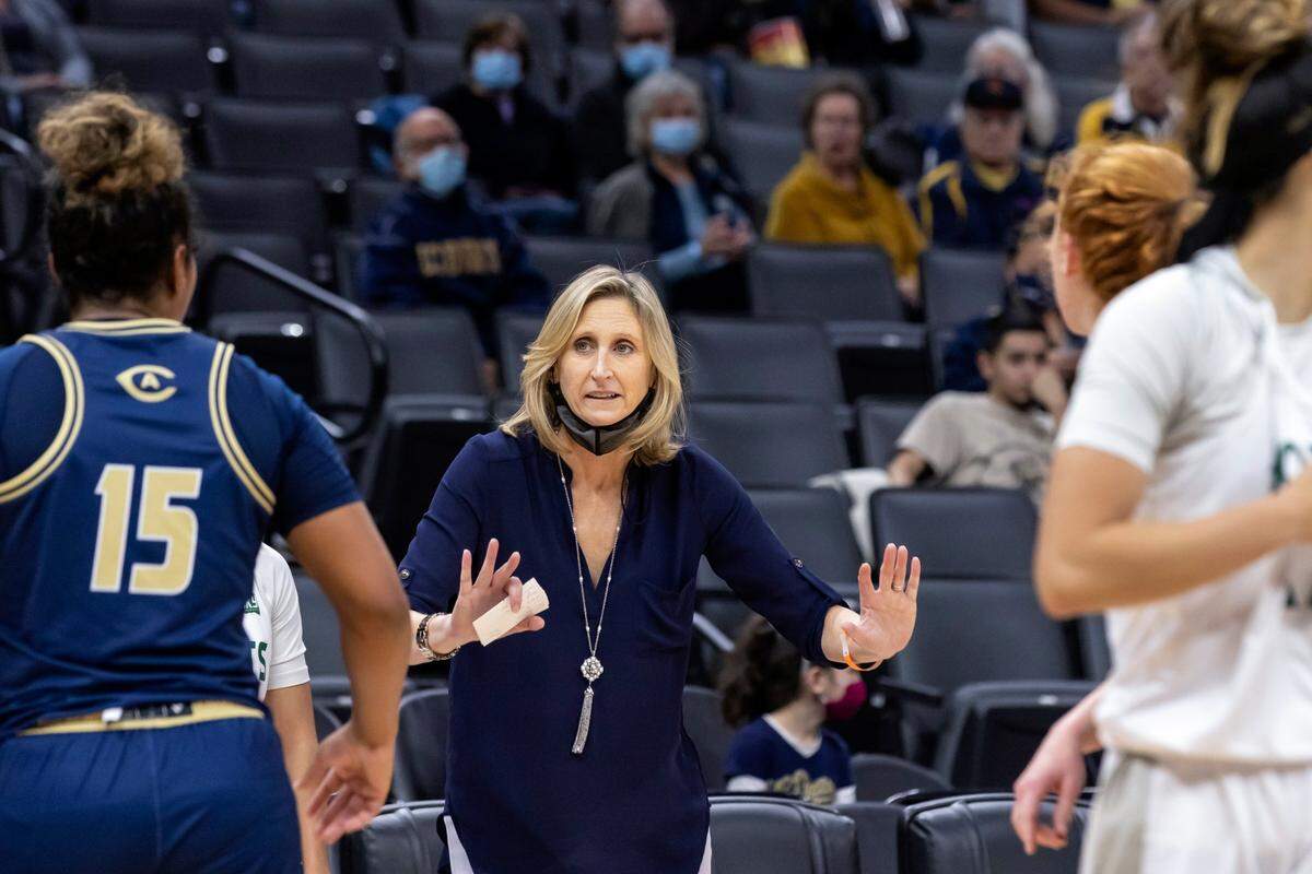 UC Davis women’s basketball coach Jennifer Gross, now in her 11th season leading the Aggies, talks to a player during a game against Sacramento State at Golden 1 Center in November. Goss set records and led UCD to the Division II Elite Eight in the 1990s, during the time the first student athletics fee was passed.