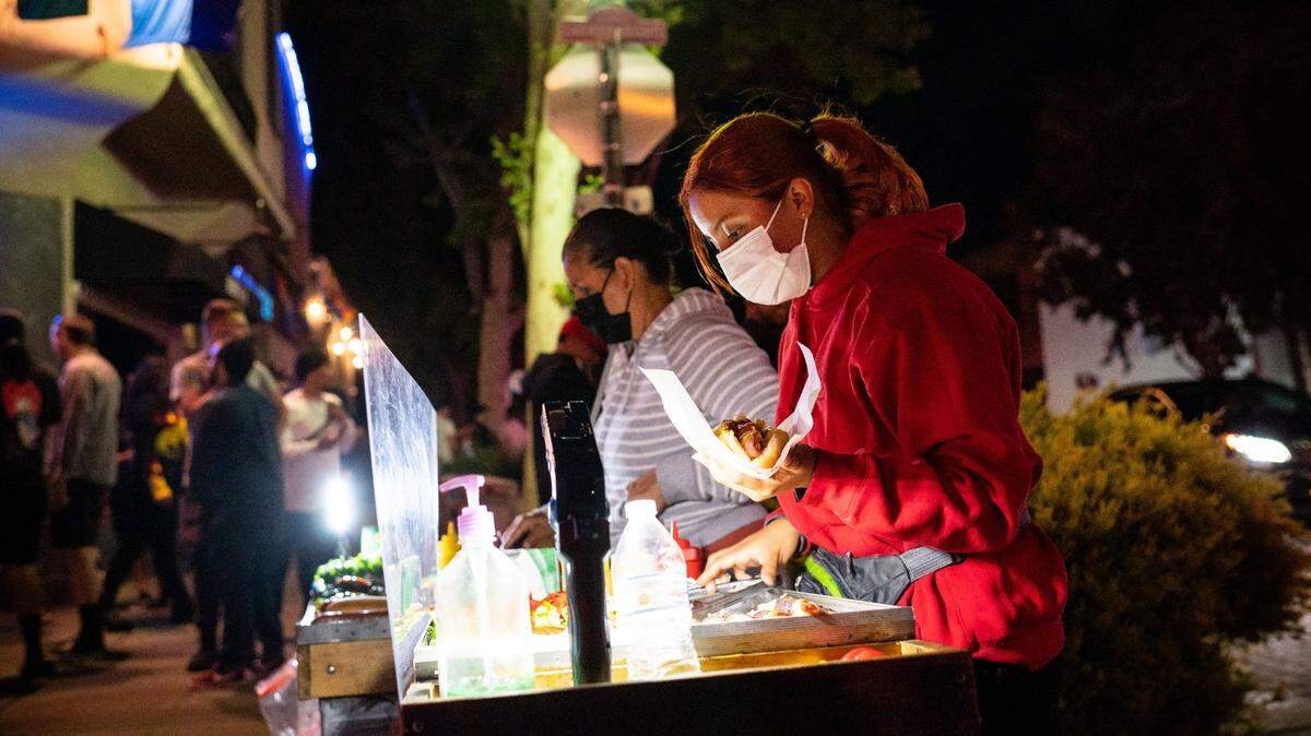 A vendor prepares hot dogs on J Street in midtown Sacramento in June.