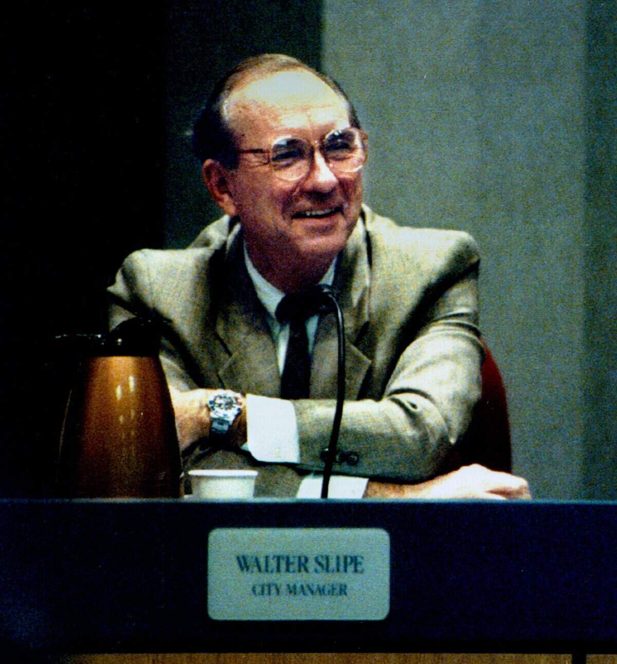 Sacramento City Manager Walter Slipe laughs as he listens to City Council members' comments after he announced his retirement at a council meeting in 1993.