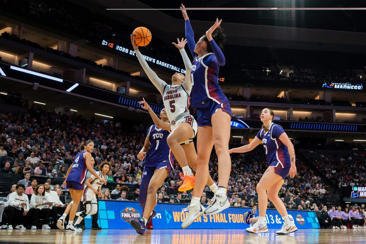 South Carolina Gamecocks guard Tessa Johnson (5) drives to the basket by Texas Christian University Horned Frogs guard Taylor Bigby (1) during the NCAA Women’s Basketball Tournament Elite 8 at Golden 1 Center in Sacramento on Monday.