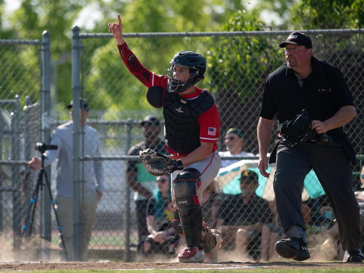 McClatchy High School catcher Malcolm Moore points toward fly ball hit by Kennedy High School’s Francisco Castillo on Wednesday during the teams’ first game back since the start of the teachers strike in Sacramento.