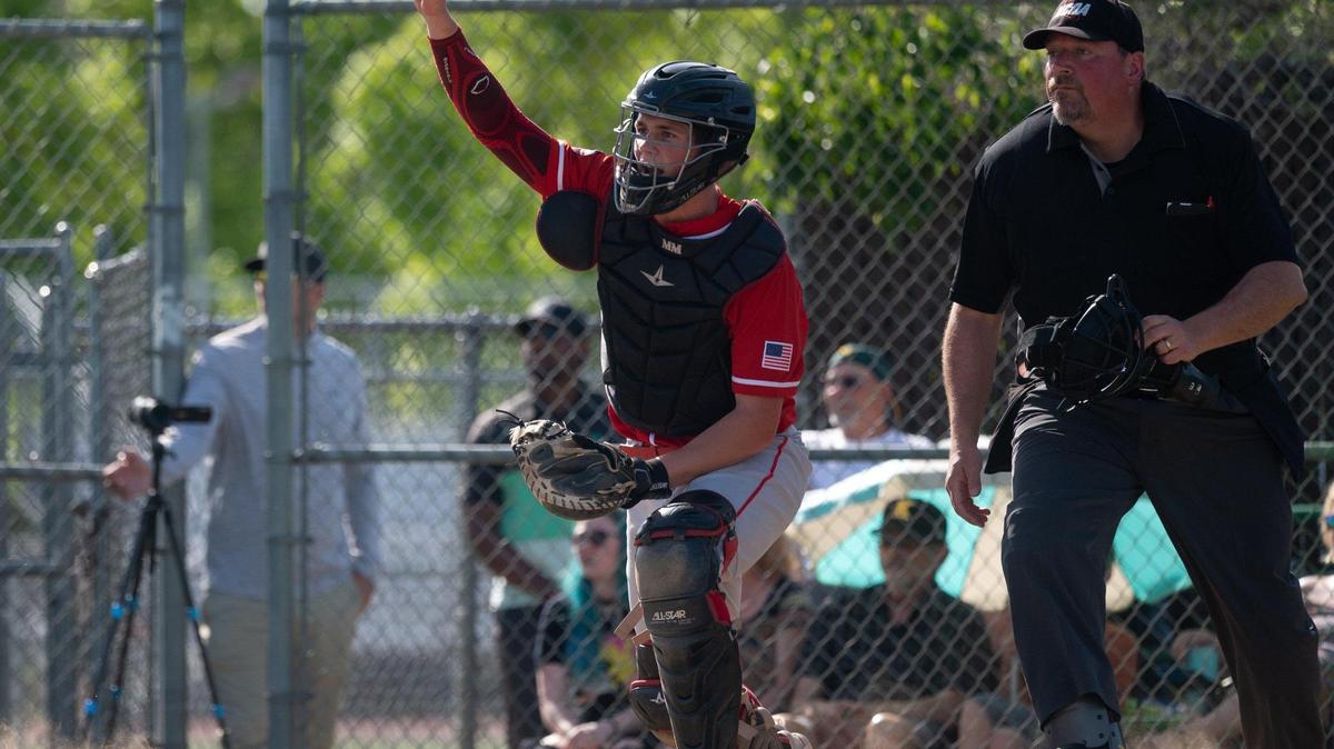 McClatchy High School catcher Malcolm Moore points toward fly ball hit by Kennedy High School’s Francisco Castillo on Wednesday, April 6, 2022, during the teams’ first game back since the start of the teachers strike in Sacramento.