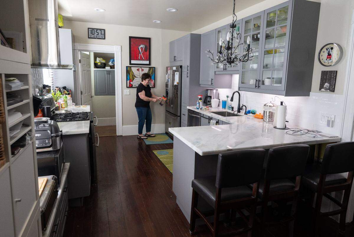 Barbara Holmes, who lives in the Sacramento house where serial killer Dorothea Puente committed her crimes, fills a pitcher in her kitchen Friday, Oct. 18, 2024.