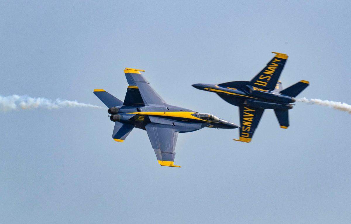 Two U.S. Navy Blue Angels F/A-18 Hornets fly past each other at the California Capital Airshow at Mather Airport on Saturday, March 22, 2025.