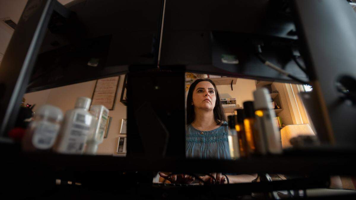 Department of General Services employee Monica Hassan telecommutes from her home office on Thursday, Nov. 18, 2021, in Sacramento. Some state agencies have recently pushed for workers to return to the office at least twice a week.