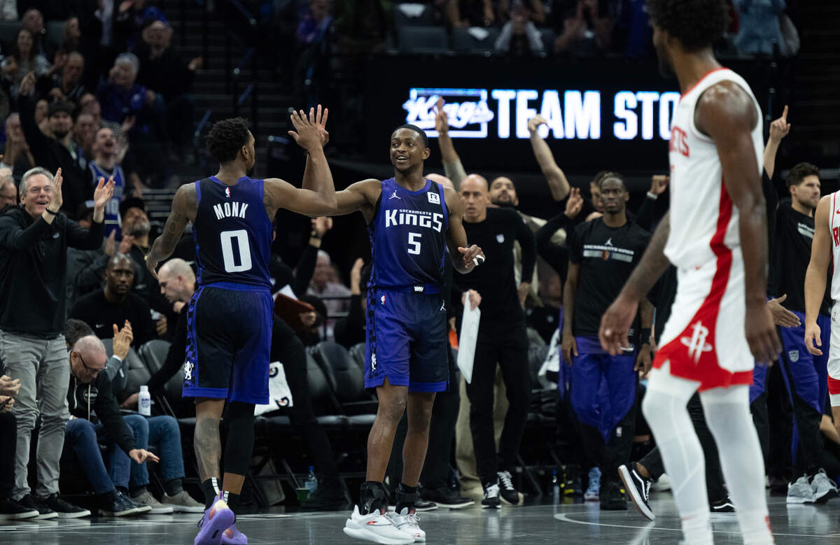 Sacramento Kings guard Malik Monk (0) and guard De’Aaron Fox (5) react after a basket during an Emirates NBA Cup game at Golden 1 Center on Tuesday.