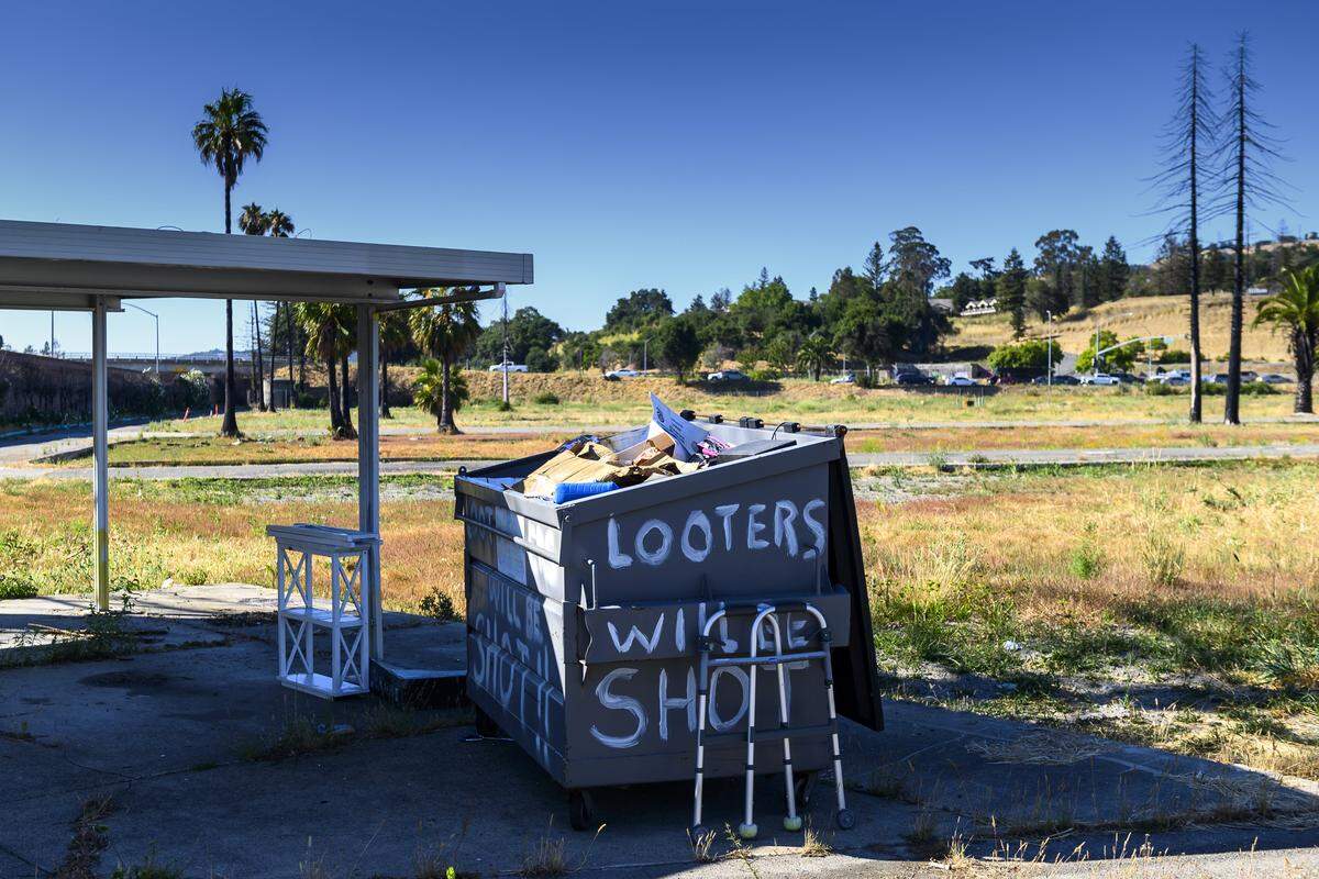 A walker lays up against dumpster full of debris from the Journey’s End mobile home park in Santa Rosa on Monday, July 22, 2019. 117 mobile homes in Journey’s End where burned when the Tubb’s fire breached the Santa Rosa city limits on October, 9, 2017. Many former residents face problems with their mental health due to the trauma caused by the fire.