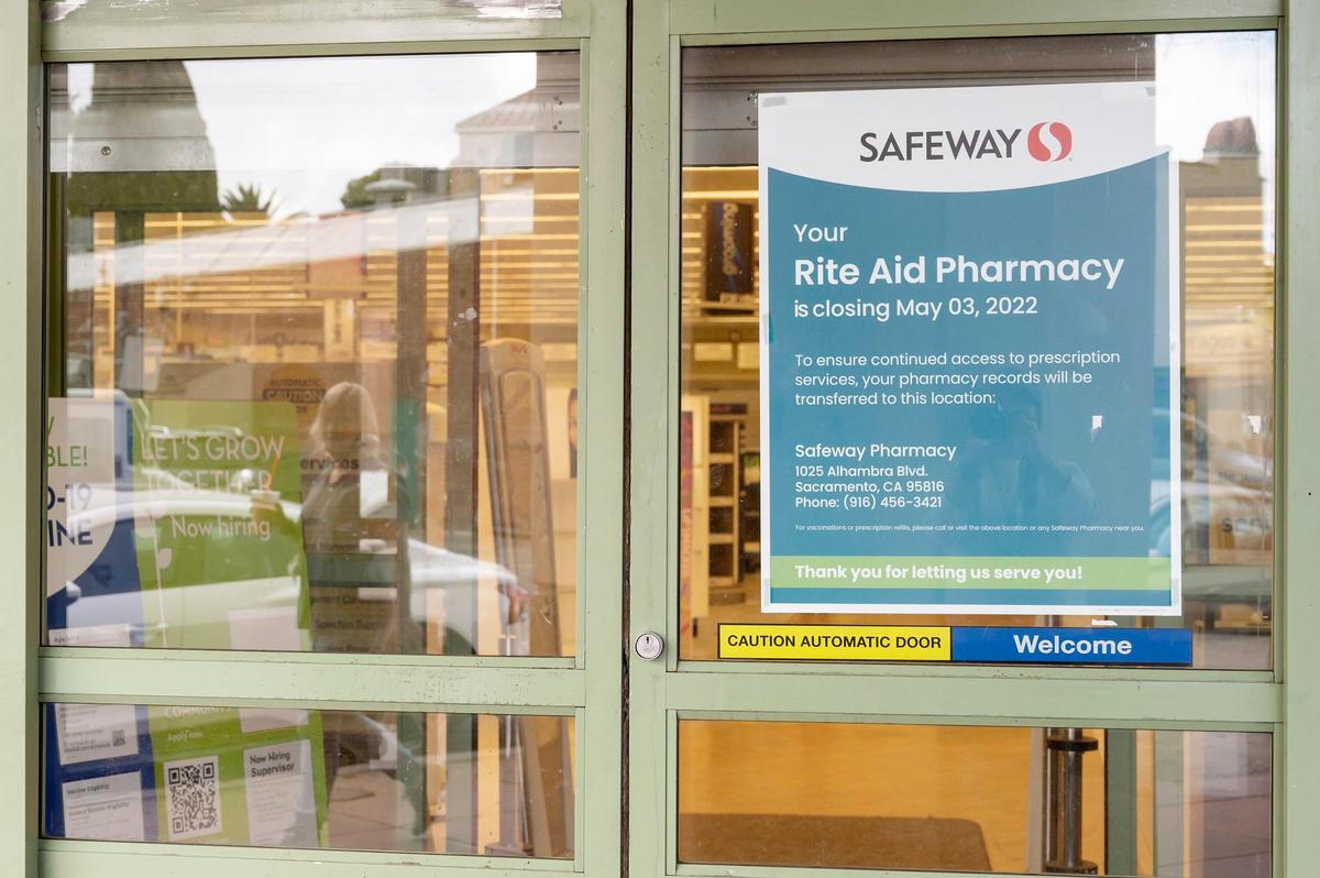A woman walks by the closed Rite Aid at 1125 Alhambra Blvd. on Monday, May 9, 2022, in East Sacramento.