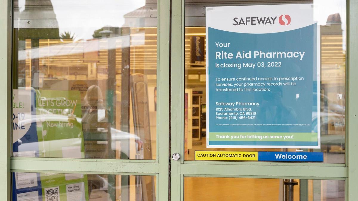 A woman walks by the closed Rite Aid at 1125 Alhambra Blvd. on May 9, 2022, in East Sacramento.