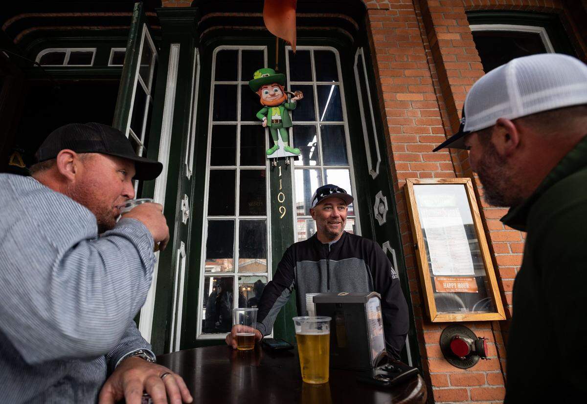 Donald Eva, center, visiting from Las Vegas, drinks outside with friends at OMallys Irish Pub in Old Sacramento on St. Patricks Day on Wednesday, March 17, 2021, as Sacramento County shifts into the less-restrictive red tier.