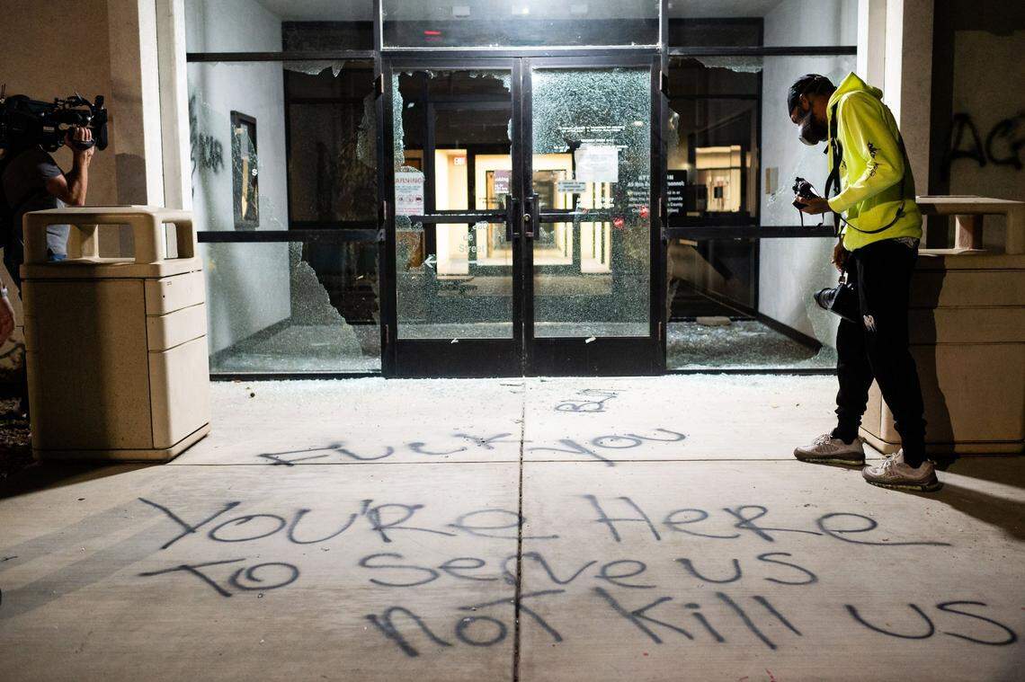 News photographers document damage at the Sheriffs Department building after demonstrators at a second of two planned protests vandalized the entryway Thursday, Aug. 27, 2020, in downtown Sacramento. The “Solidarity With Kenosha” event started at Cesar E. Chavez Plaza, and left many government buildings with broken windows and graffiti. 