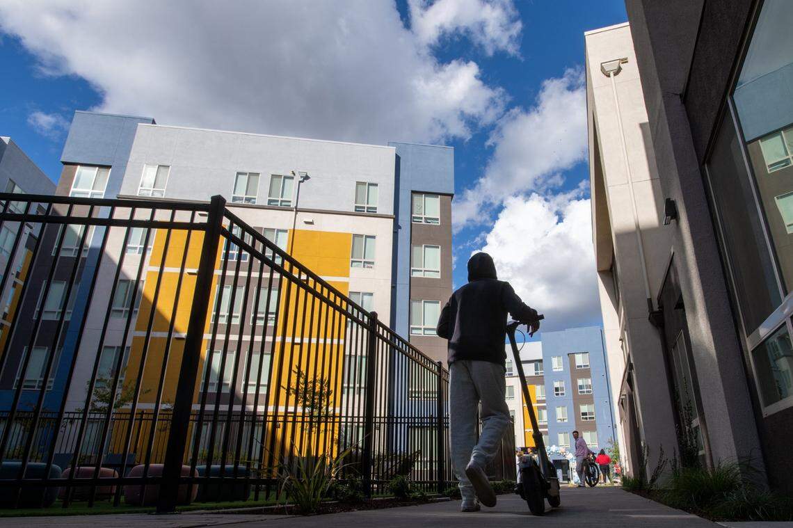 Sacramento State student Hiren Parmar walks his scooter Wednesday, Nov. 2, 2022, at the Wexler, a new student apartment building located next to Sacramento Regional Transit’s University/65th Street light rail and bus station in East Sacramento. The 223-unit Wexler houses more than 700 students.