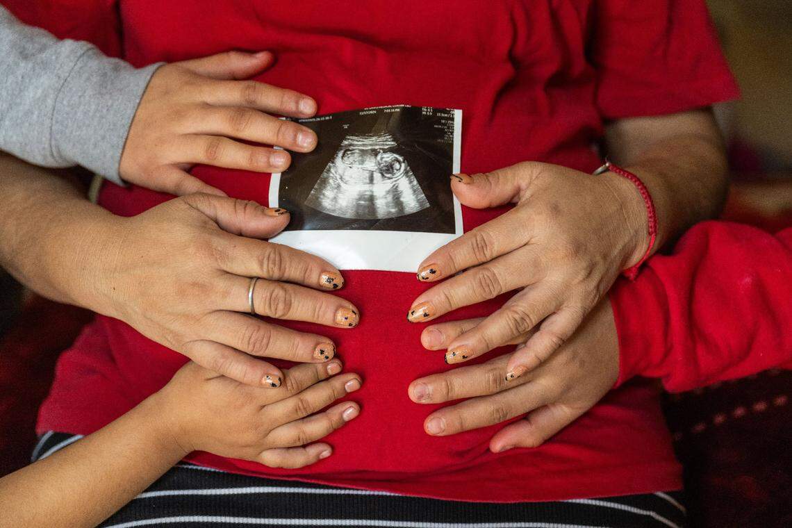 A mother who escaped violence in Mexico and her three children hold the ultrasound for her fourth child in January. Her family, which has requested anonymity for fear of deportation and retaliation, welcomed the boy – a U.S. citizen by virtue of birthright citizenship – about four months later.