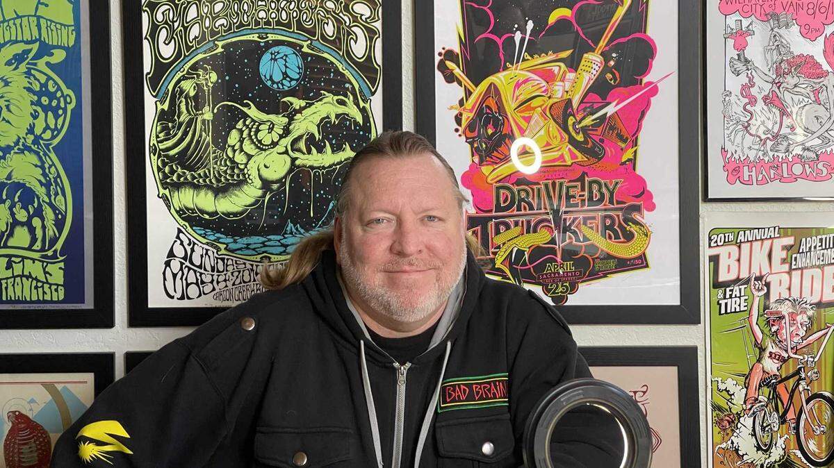 Brian McKenna pictured in front of flyers from shows he promoted or attended. The concert promoter was recently hospitalized and local musicians are raising money for his medical expenses with a concert Monday at Harlow’s in midtown Sacramento.