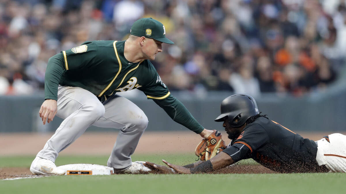 Matt Chapman, left, and the A’s won four of six over Alen Hanson and the Giants in the 2018 Bay Bridge Series. The teams will meet in August 2019 for four games.