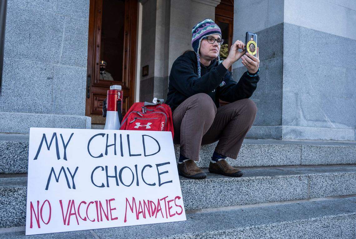 Citrus Heights resident Andrea Hedstrom records a rally protesting vaccine mandates for school children on Oct. 18 at the State Capitol. Hedstrom said that attending these rallies are only a small part of her efforts to lobby legislators to stop laws that she feels are intruding on the personal liberties of her and her family.