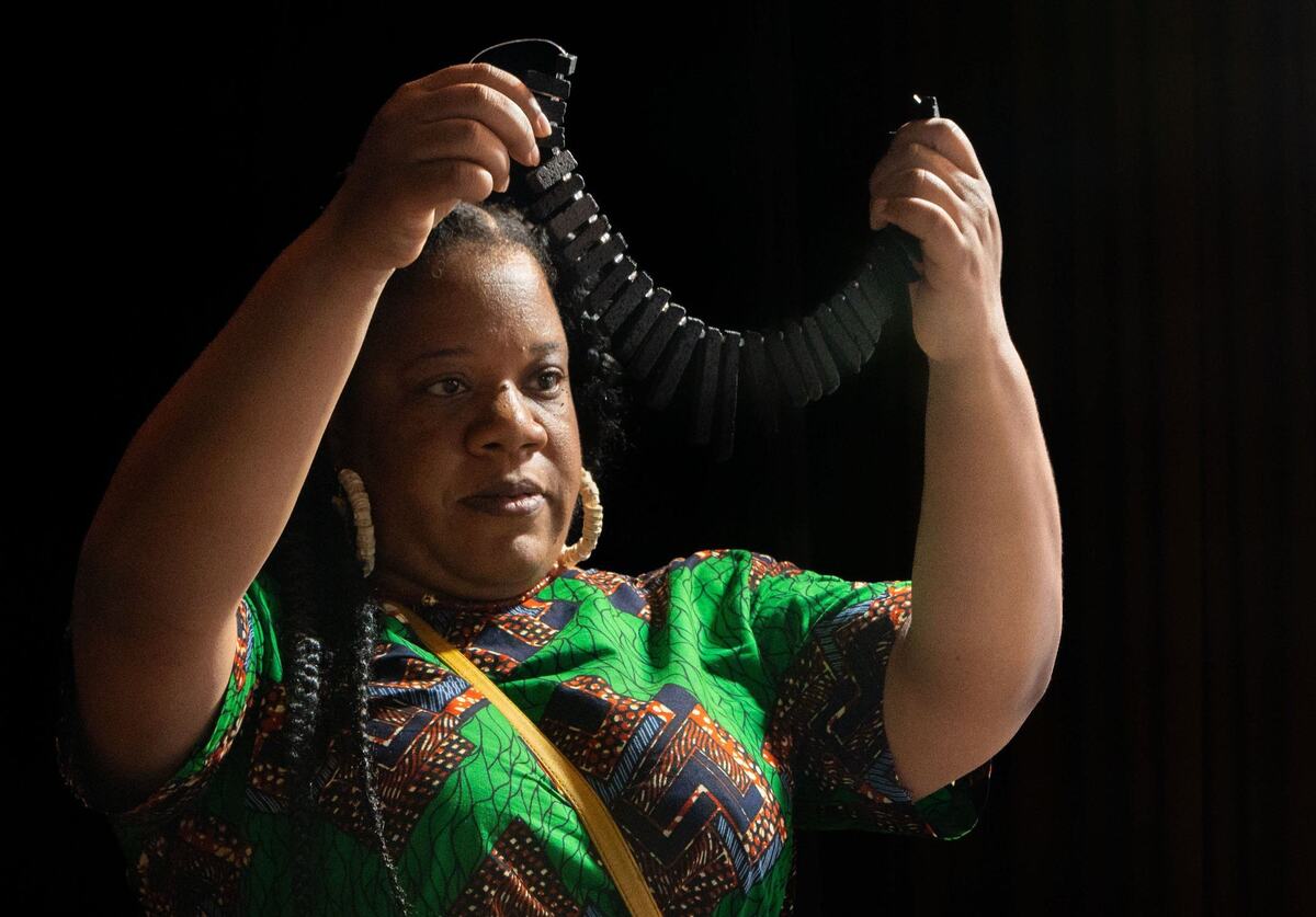Danielle Williams holds up a string of rough beads during the Gem Faire at the Scottish Rite Masonic Center in Sacramento on Friday, Aug. 2, 2024. “When you come here and you touch the beads and you actually see them, the design comes in and the creativity comes in,” Williams said.