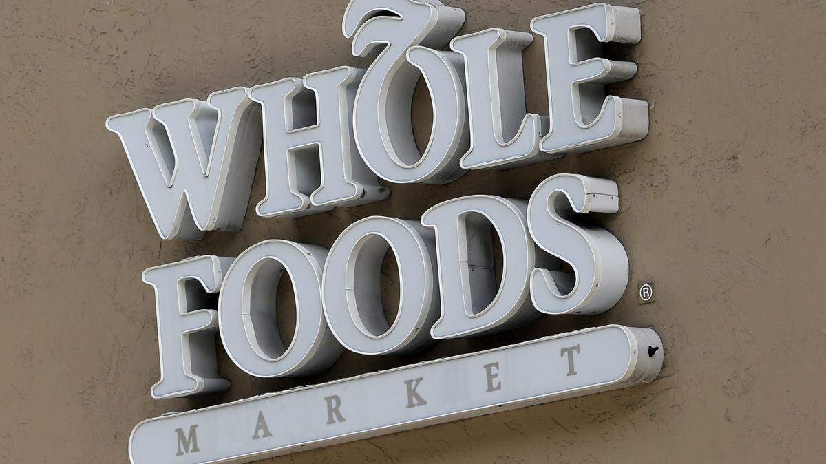 A Whole Foods Market sign is seen in 2017 at a store in Coral Gables, Fla. Developers are asking for a city loan to open a Whole Foods location in midtown at 16th and J streets.