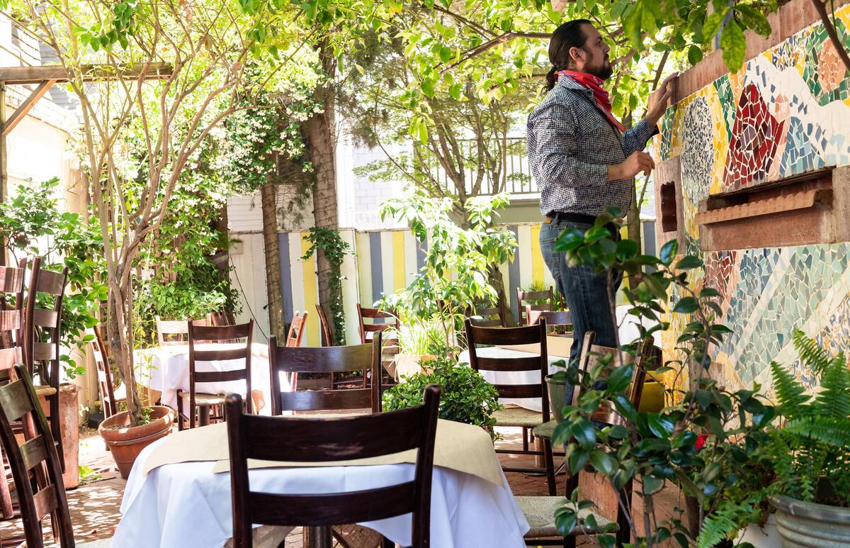 Aziz Bellarbi-Salah, owner of Aïoli Bodega Española on L Street, prepares an outdoor seating area Friday, May 22, 2020, in Sacramento. Sacramento County’s updated Stage 2 coronavirus guidelines allowed restaurants to open Friday for inside and outside dining, with some restrictions.