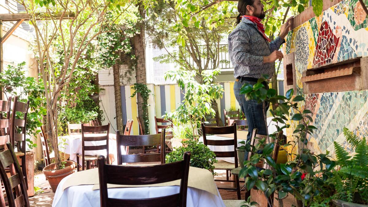 Aziz Bellarbi-Salah, owner of Aïoli Bodega Española on L Street, prepares an outdoor seating area Friday, May 22, 2020, in Sacramento. S Sacramento County’s updated Stage 2 coronavirus guidelines allowed restaurants to open Friday for inside and outside dining, with some restrictions.