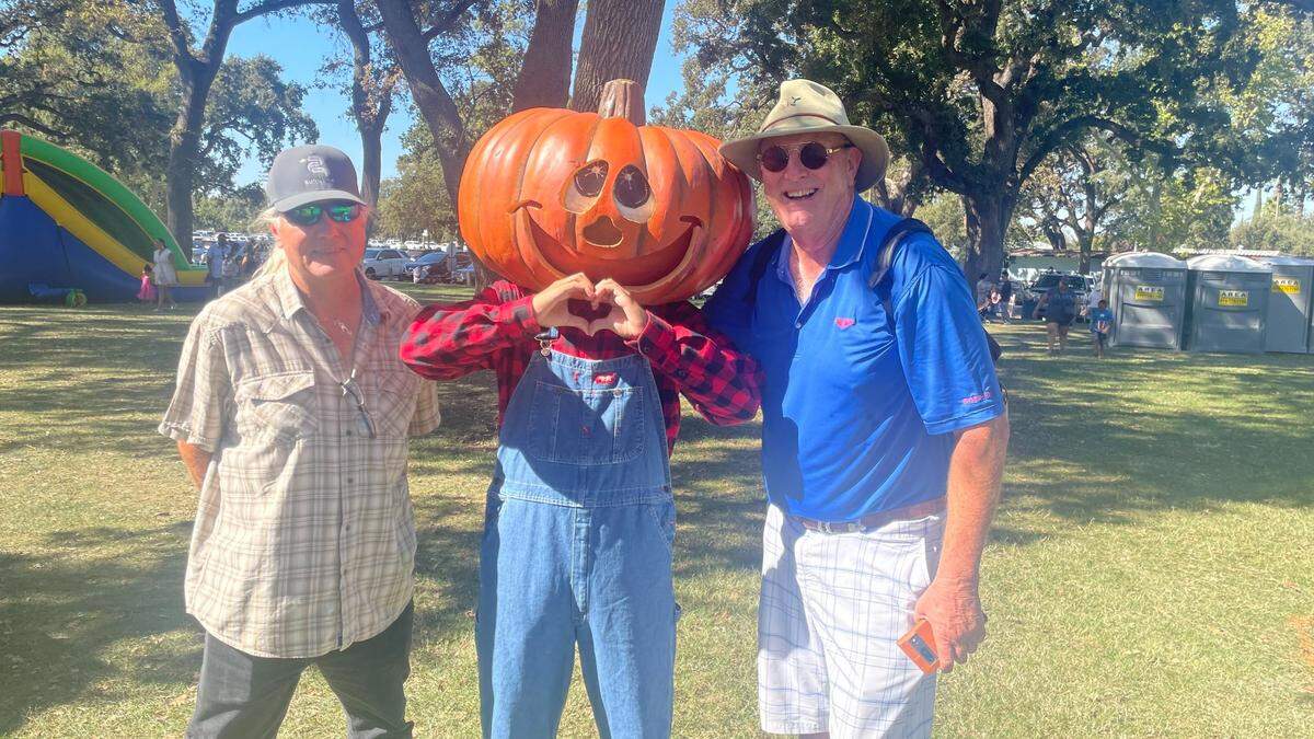 Michael John Ahern, right, poses with the Giant Pumpkin Festival mascot and his friend Chris Cotruvo on Saturday, Oct. 7, 2023.