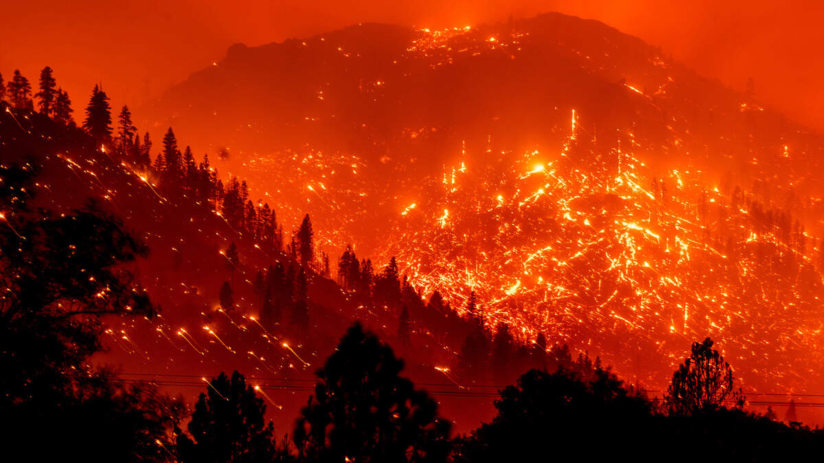 Embers light up hillsides in Lassen County during last year’s Dixie Fire.