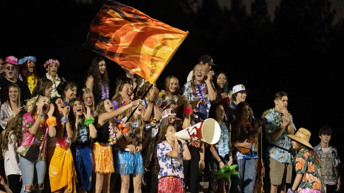 The Foresthill High School “Fire pits” cheer for their team during a game against Valley Christian Lions at Foresthill High School in Foresthill on Friday. It was their first home game since the Mosquito Fire.