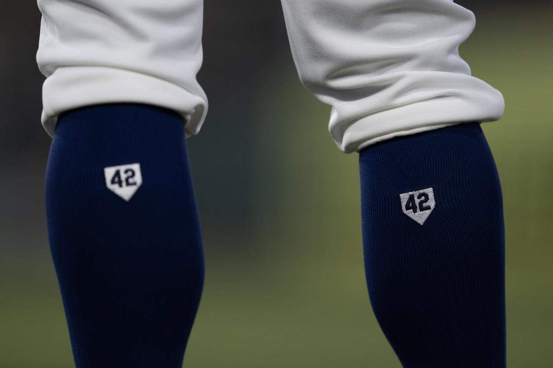Athletics first base coach Ryan Christianson wears the No. 42 on his socks on Jackie Robinson Night during the game against the Texas Rangers at Sutter Health Park on Wednesday in West Sacramento.
