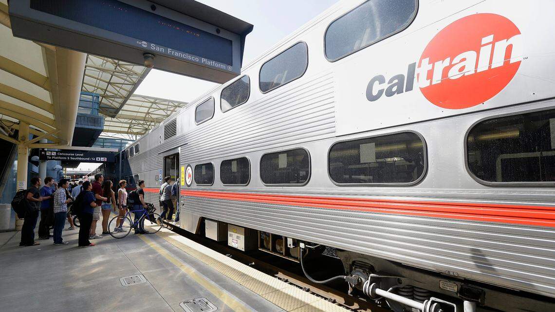 FILE - In this July 1, 2013, file photo, commuters board a Caltrain train at the Caltrain and Bay Area Rapid Transit station in Millbrae, Calif. Johan Strydom faces hate crime charges after he allegedly assaulted an Asian woman at a San Jose train station, Santa Clara County’s District Attorney said.