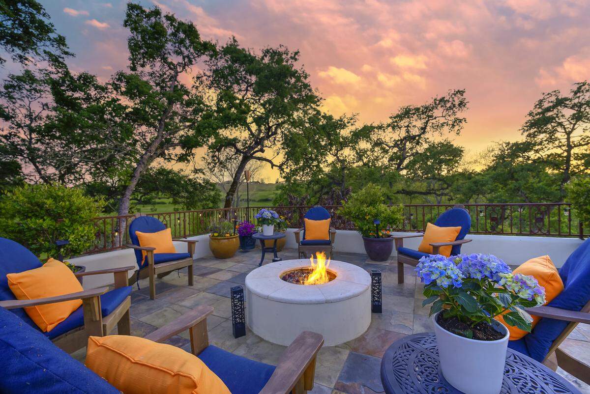A firepit in adjacent to the 51-foot infinity pool.
