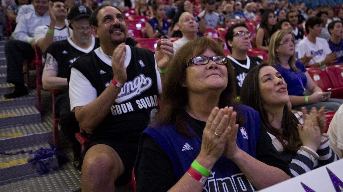 Niko, left, and Barbara Rust, center, applaud after the Kings chose Ben McLemore with the seventh pick in the NBA draft at Sleep Train Arena on June 27, 2013.