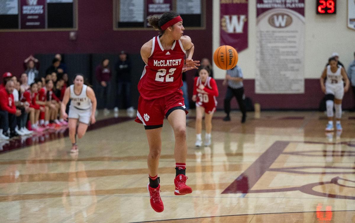 The McClatchy Lions’ Nina Cain passes the ball behind her back after a steal against the Whitney Wildcats in a CIF Northern California regional girls basketball championship quarterfinal last season at Whitney High School.