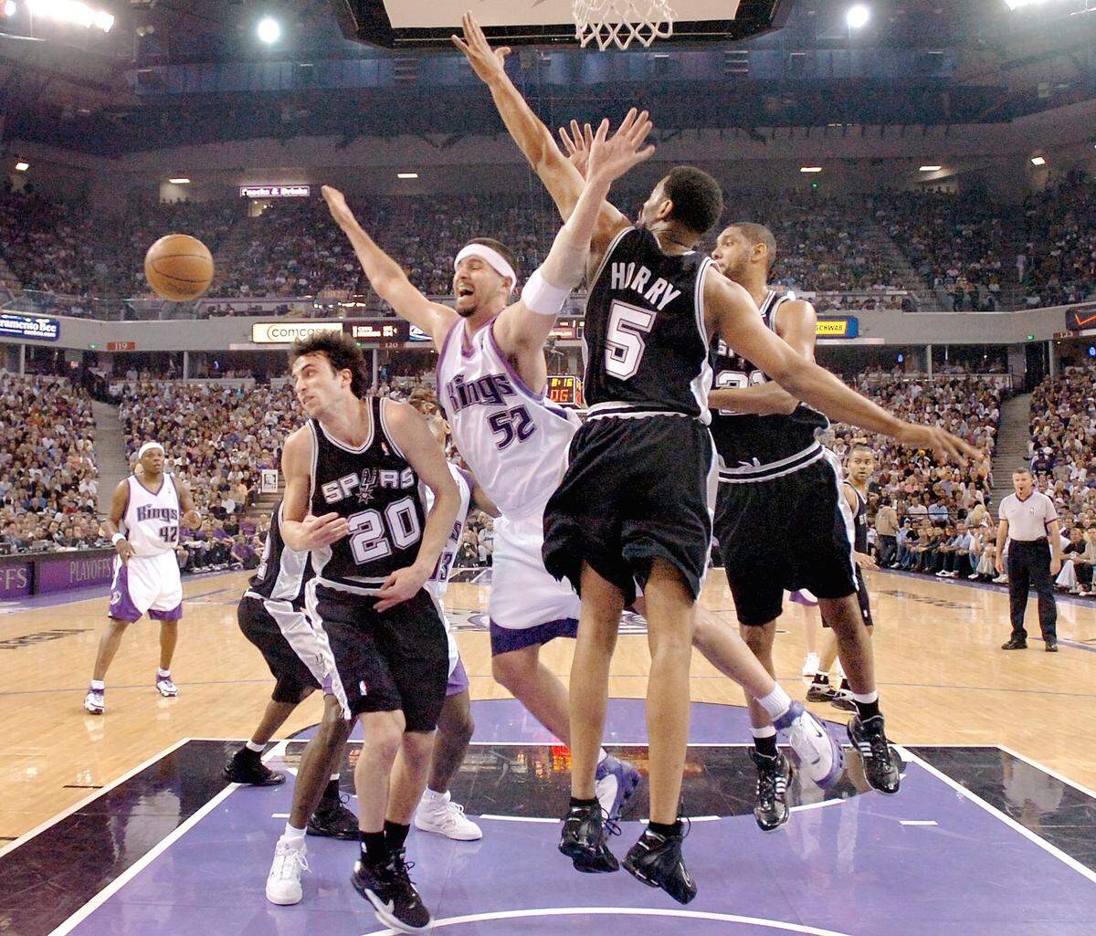 Kings center Brad Miller loses the ball while being defended by Spurs Robert Horry and Manu Ginobili, left, in Game 6 of the first round of Western Conference playoff series between the Sacramento Kings and San Antonio Spurs at Arco Arena on Friday, May 5, 2006.