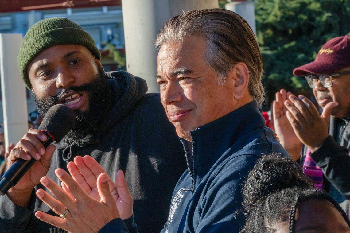California Attorney General Rob Bonta applauds as Chinua Rhodes, left, a Sacramento City Unified School District board member, speaks at the March for the Dream onoring Martin Luther King Jr. at Sacramento City College on Monday. “He is someone whose life and whose legacy has inspired many of us over decades over many years to fight for justice,” Bonta said of King.