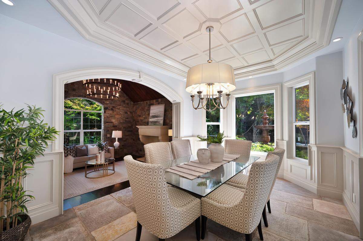 Vaulted beamed ceilings and reclaimed hardwoods set an inviting tone in the elegant, open living areas.