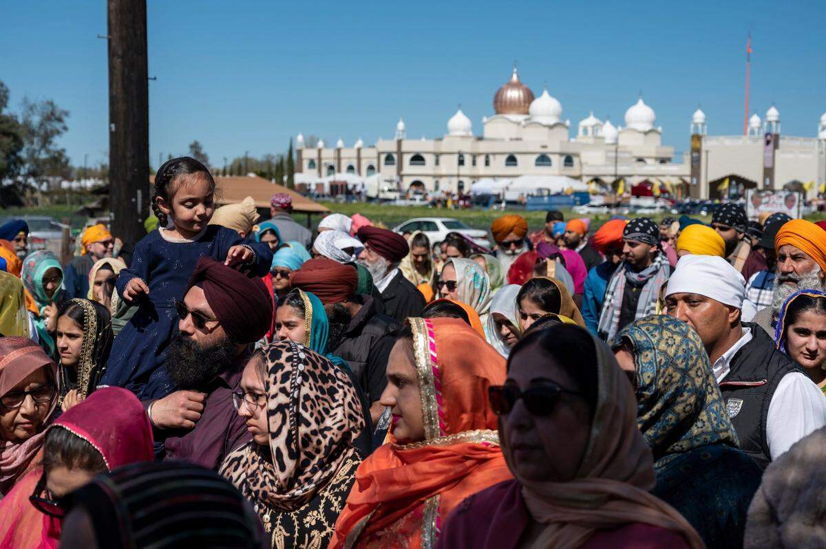 People fill Bradshaw Road as they walk past the Sacramento Sikh Society temple in Vineyard during the society’s first Nagar Kirtan parade in March. The Central Vallley has a large Sikh population.