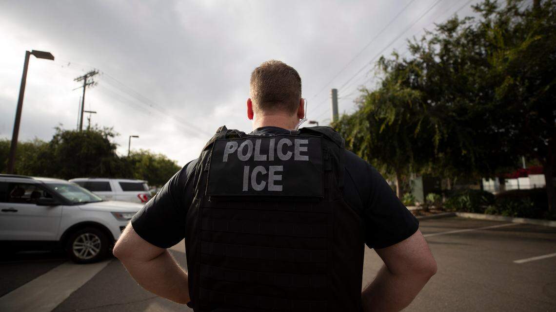 FILE - In this July 8, 2019, file photo, a U.S. Immigration and Customs Enforcement (ICE) officer looks on during an operation in Escondido, Calif. San Diego County Sheriff Bill Gore says he will comply with U.S. Immigration and Customs Enforcement’s request for information on four people with criminal records, becoming the first state or local law enforcement official in the country to so honor such requests among a spate of jurisdictions whose laws sharply restrict cooperation with immigration authorities. (AP Photo/Gregory Bull,File)