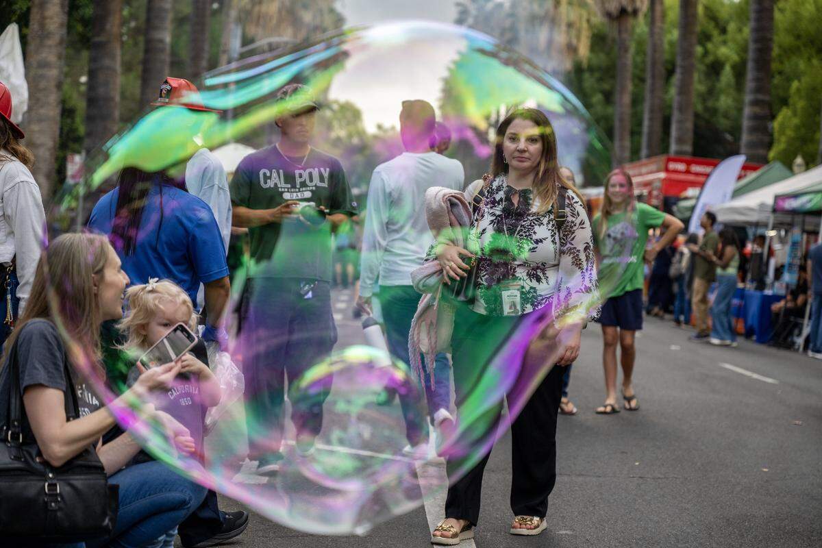 Visitors admire bubbles created by Shane Romick of the Aries Moon Circus during a 175th birthday block party to celebrate California's anniversary of statehood on Tuesday, Sept. 9, 2025, at the state Capitol.