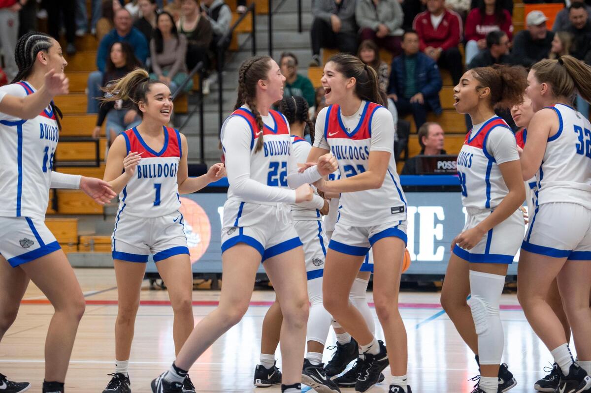 The Folsom Bulldogs celebrate their win in the CIF Sac-Joaquin Section Division I girls semifinal game against the McClatchy Lions on Tuesday, Feb. 21, 2023, at Folsom High School. The Bulldogs won 57-52.
