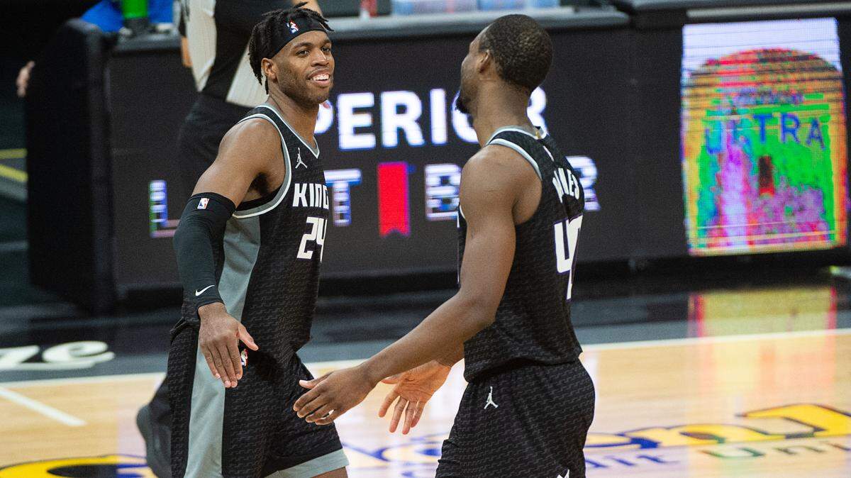 Sacramento Kings guard Buddy Hield (24) congratulates Sacramento Kings forward Harrison Barnes (40) after making two free throws with seconds left in the fourth quarter during a game at Golden 1 Center on Wednesday, Mar. 3, 2021 in Sacramento. The Kings win 123-121.