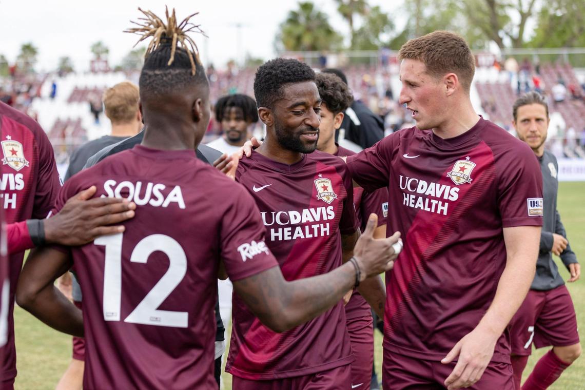 Sacramento Republic FC defender Duke Lacroix, center, is congratulated for scoring the winning goal by teammates Ferrety Sousa and Dan Casey after the USL soccer match against Tulsa on Sunday at Heart Health Park.