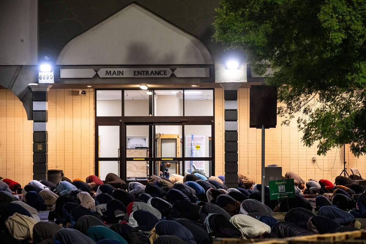 In a sectioned off part of the parking lot at Masjid Annur Islamic Center in south Sacramento, worshippers wear masks and are distanced more than usual on Tuesday.